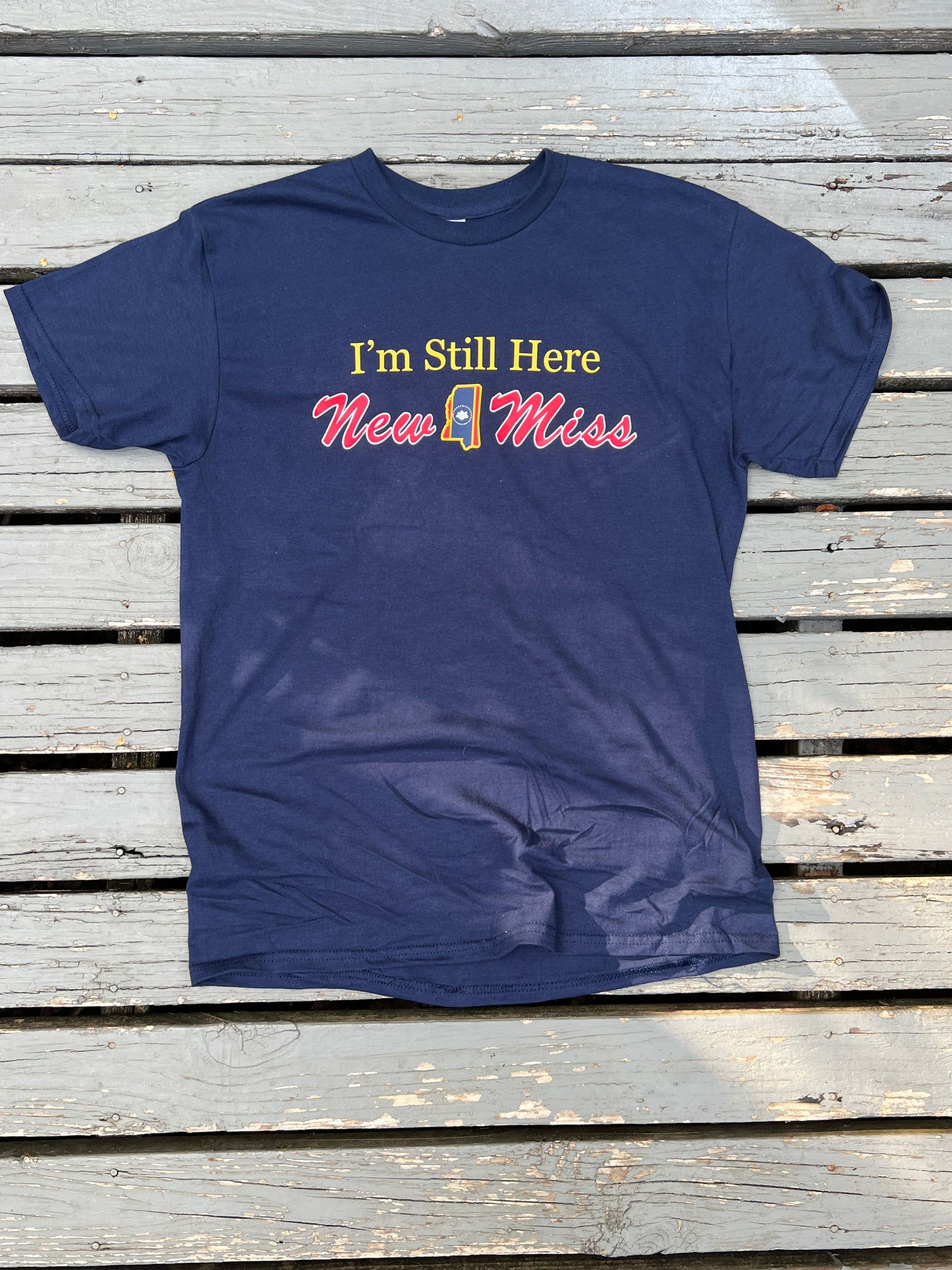 Limited Edition short sleeve Navy T-shirt featuring " I'm Still Here" with New Miss and State cutout.