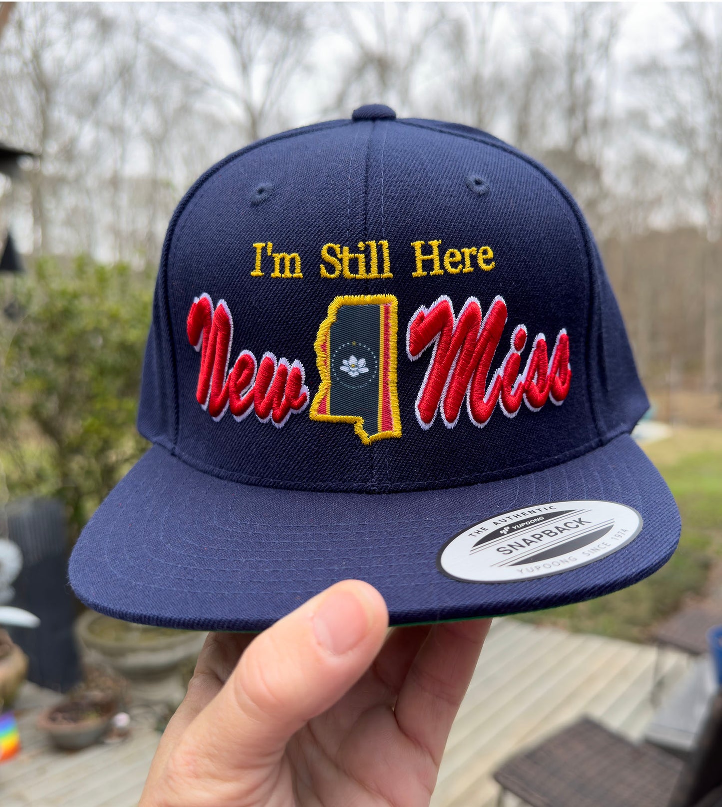 **New** " I'm Still Here" -Limited Edition Navy FLAT BRIM STRUCTURED Hat featuring New Miss logo and Flag cutout